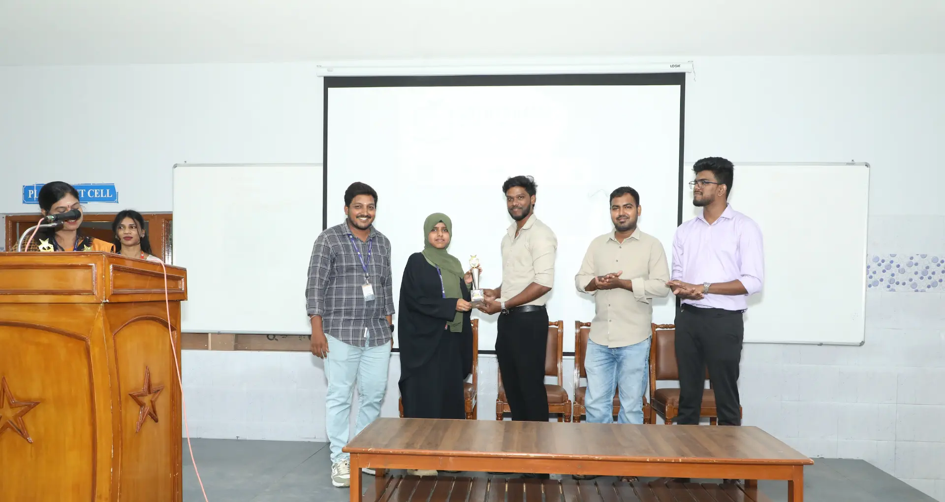 A student receiving a trophy during the B2E campus program award ceremony