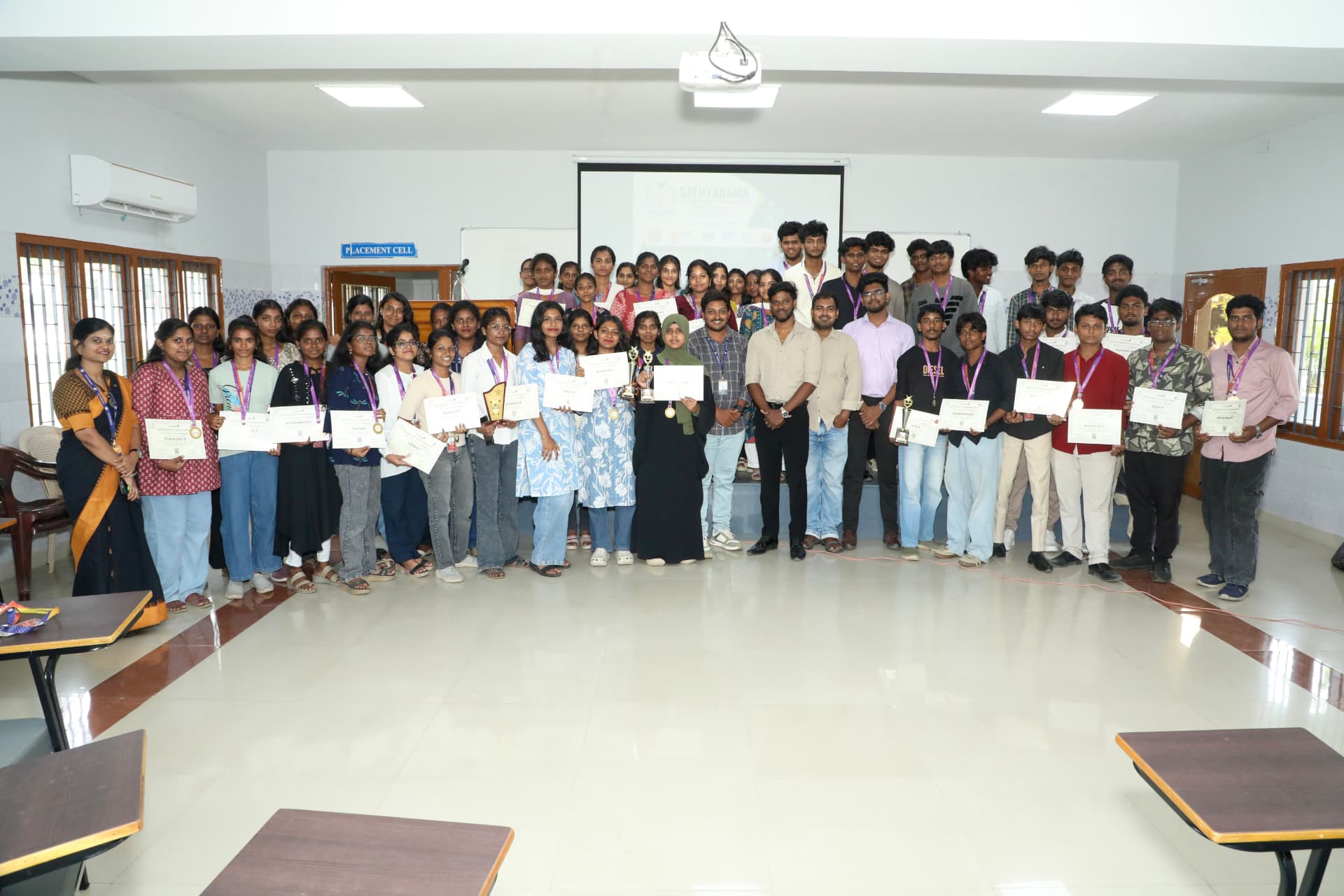 B2E campus program students and faculty celebrating with certificates and awards