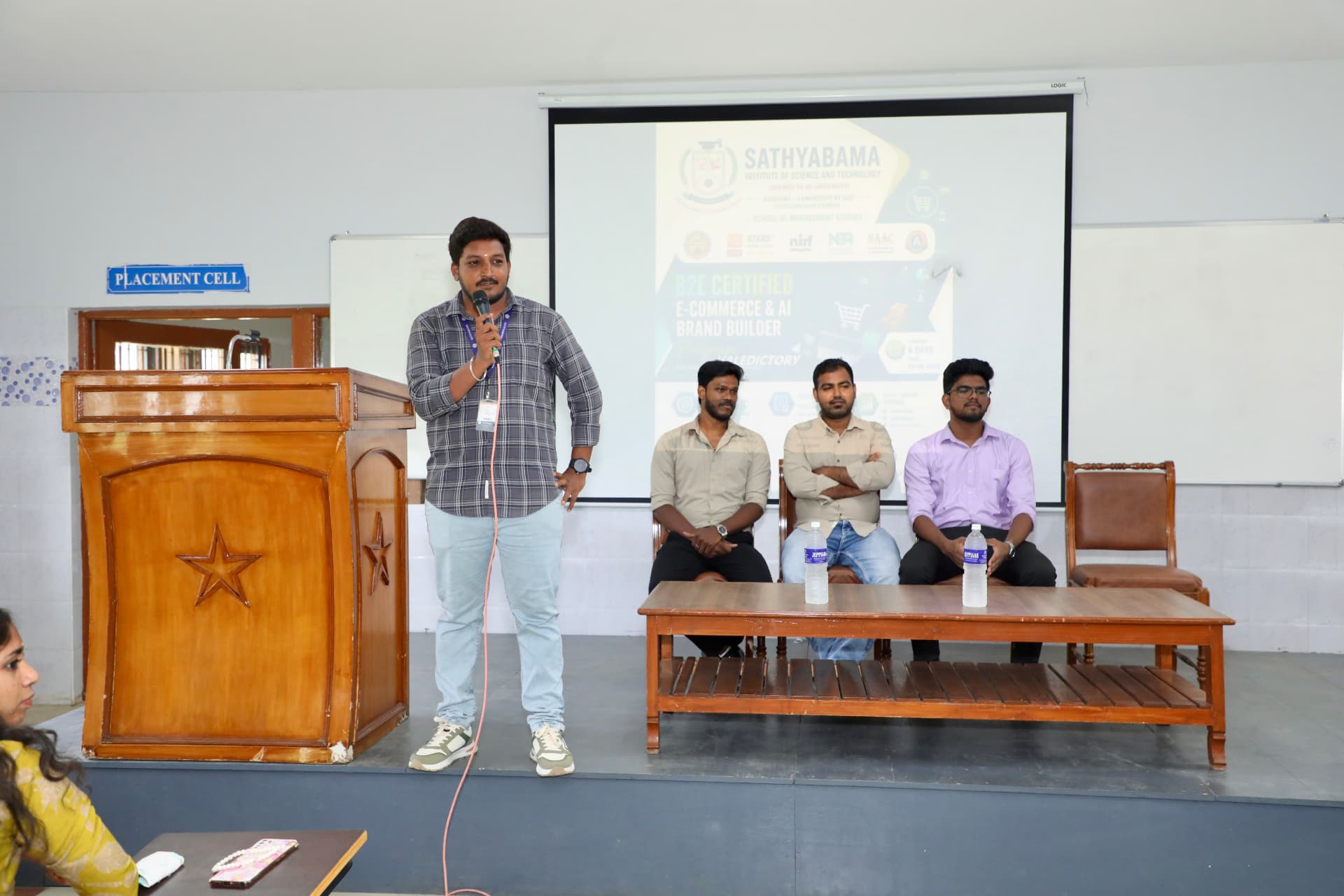 A student speaking on stage during a B2E campus program