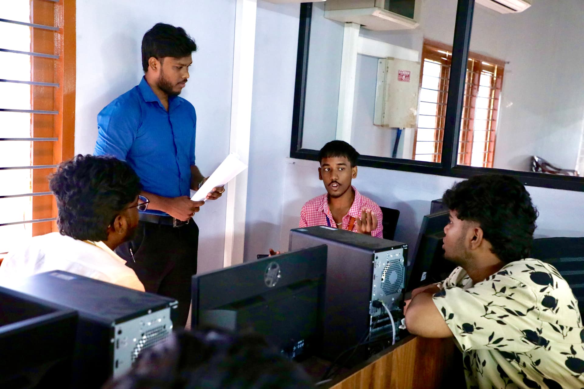 Students working with a B2E mentor during a computer lab activity